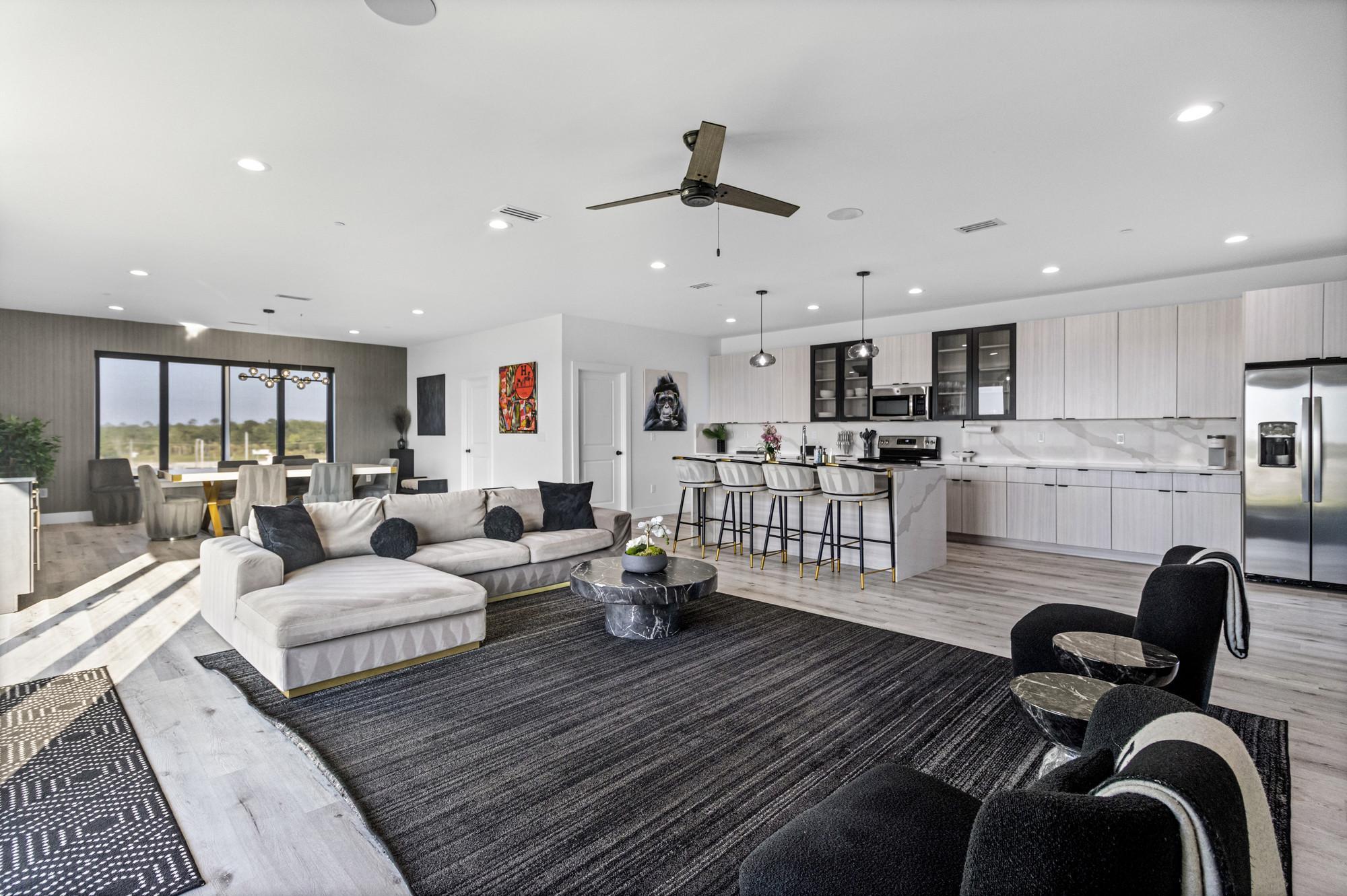 Bright open living room at The Pad with balcony doors and waterfront light